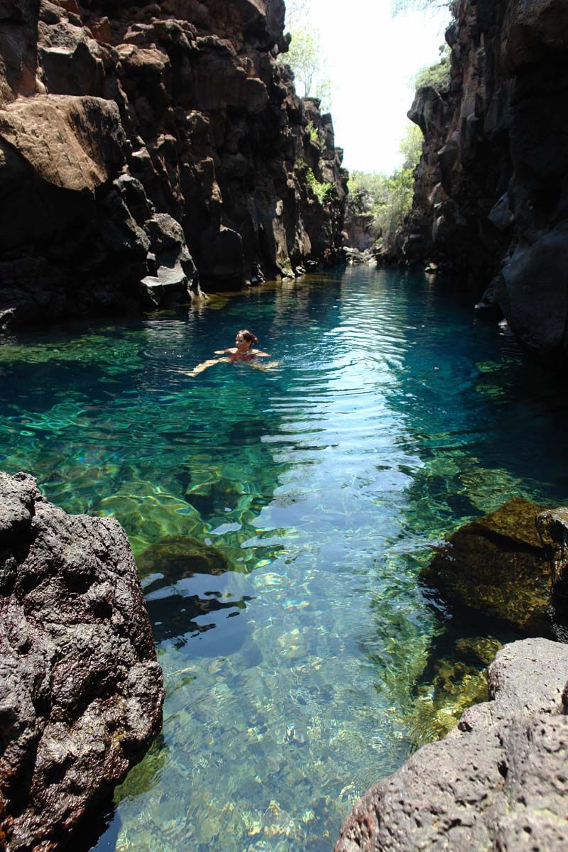 person swimming in the crystal clear waters of Las Grietas Beach