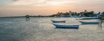 Boats floating on the waters at sunset on El Yaque in Venezuela