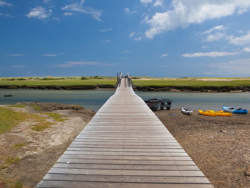 A long boardwalk leads to the active Town Neck Beach